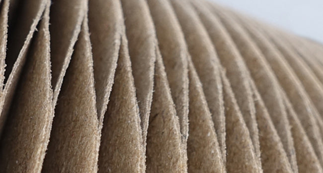 Close-up of pleated brown paper with a blurred background