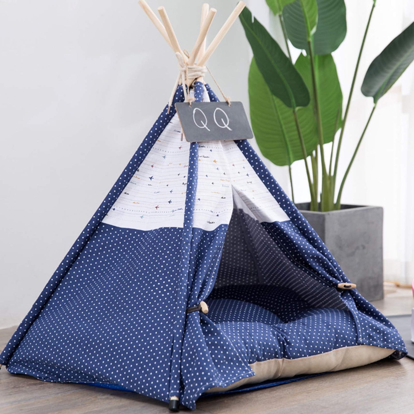Pet teepee with star pattern and a sleeping dog inside