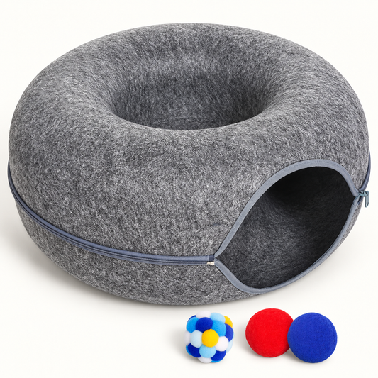 Gray felt donut cat tunnel with three colorful play balls on an off-white background.